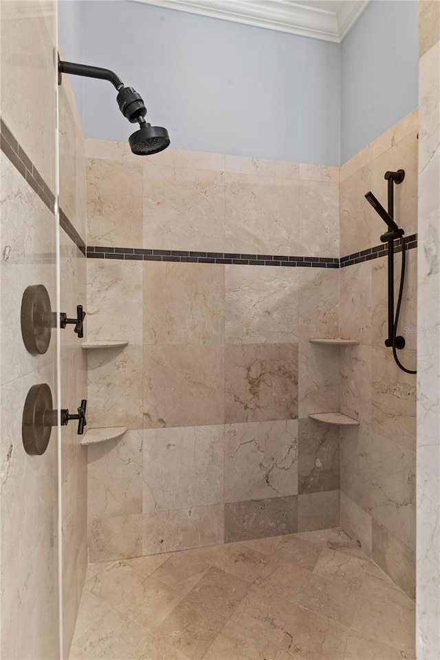 full bathroom featuring ornamental molding and a tile shower