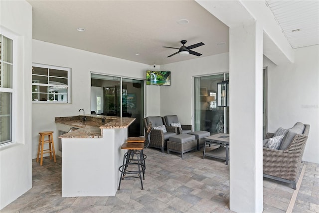 view of patio / terrace featuring outdoor dry bar, outdoor lounge area, ceiling fan, and a sink