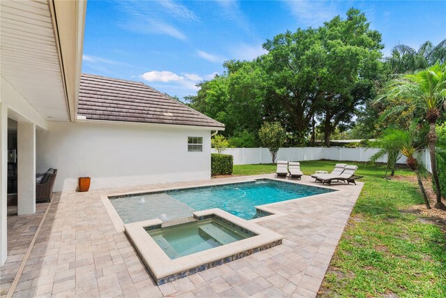 view of pool with a fenced in pool, a fenced backyard, an in ground hot tub, a lawn, and a patio