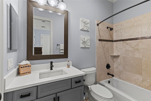 bathroom with shower / bath combination, vanity, and toilet