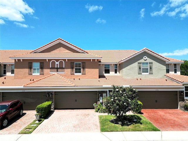 5510 Siracusa Ln, Sanford, FL 32771 - view of front of house with a tile roof, driveway, an attached garage, and stucco siding