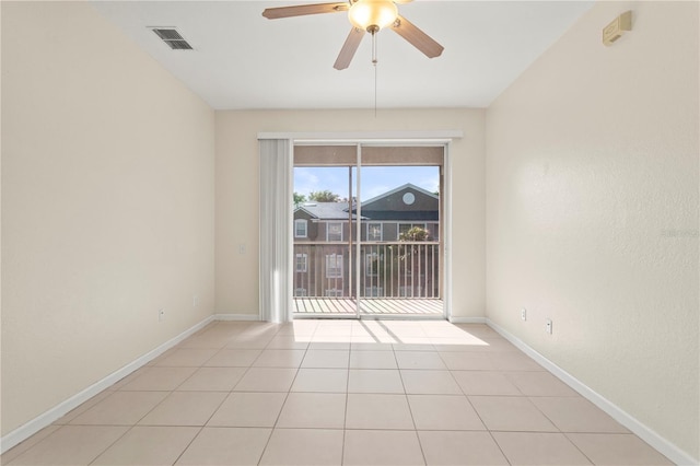 spare room featuring ceiling fan, baseboards, visible vents, and light tile patterned floors