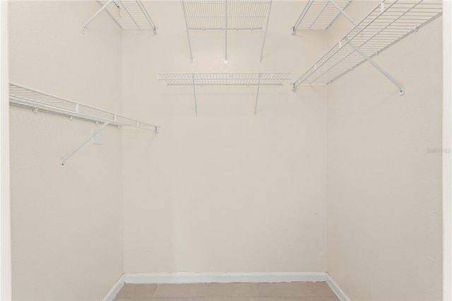 spacious closet with light tile patterned flooring