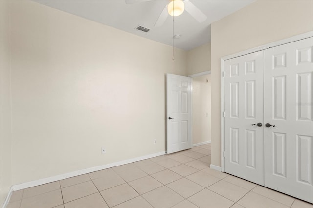 unfurnished bedroom with visible vents, a ceiling fan, light tile patterned floors, a closet, and baseboards