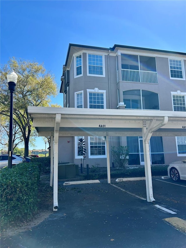 townhome / multi-family property featuring covered parking