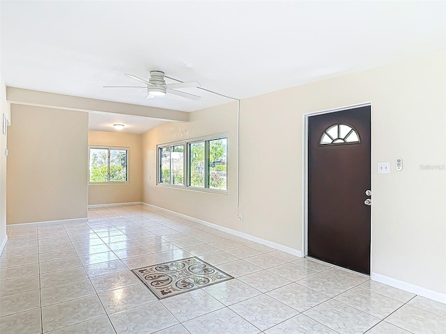4514 Southmore Dr, Orlando, FL 32812 - foyer entrance with light tile patterned flooring, a ceiling fan, and baseboards