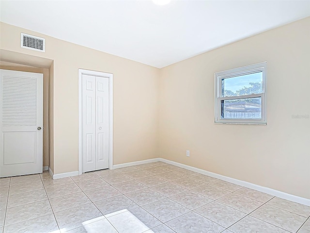 4514 Southmore Dr, Orlando, FL 32812 - unfurnished bedroom featuring light tile patterned flooring, visible vents, baseboards, and a closet
