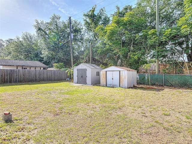 4514 Southmore Dr, Orlando, FL 32812 - view of yard featuring an outbuilding, a storage shed, and a fenced backyard