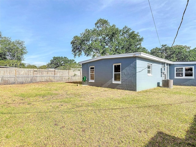4514 Southmore Dr, Orlando, FL 32812 - back of property with fence, concrete block siding, a yard, and central air condition unit
