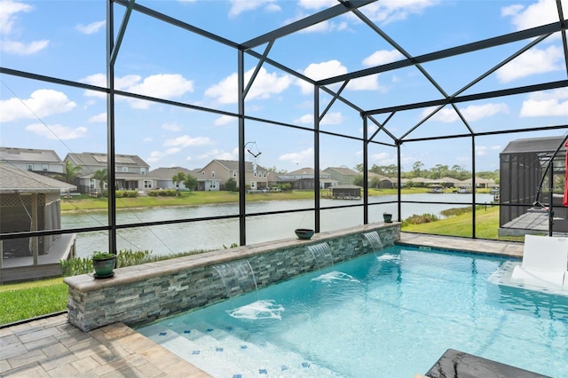 outdoor pool featuring a water view, a residential view, and glass enclosure