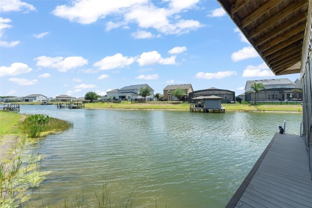 dock area featuring a water view and a residential view