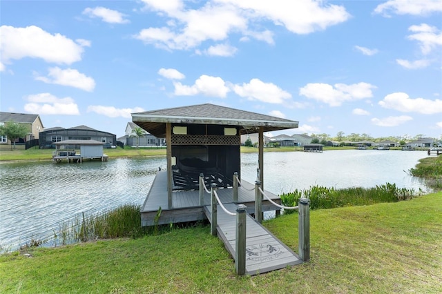 dock area featuring a yard, a residential view, a water view, and boat lift