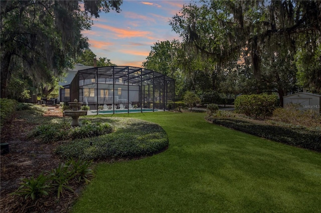 404 N Clara Ave, Deland, FL 32720 - yard at dusk with a yard, glass enclosure, and an outdoor pool