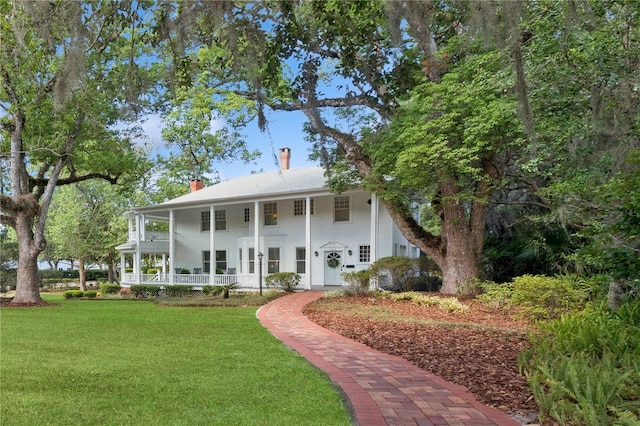 404 N Clara Ave, Deland, FL 32720 - view of front facade with covered porch, a chimney, and a front lawn