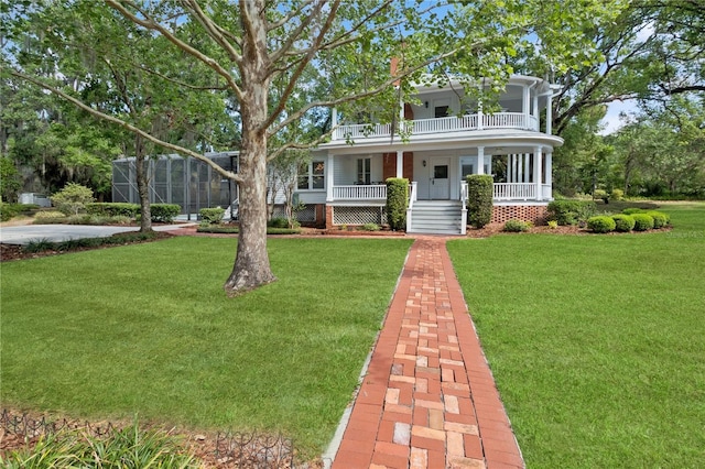 404 N Clara Ave, Deland, FL 32720 - view of front facade with a porch, a front lawn, and a balcony