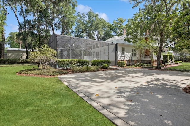 404 N Clara Ave, Deland, FL 32720 - view of front of property featuring a front yard and glass enclosure