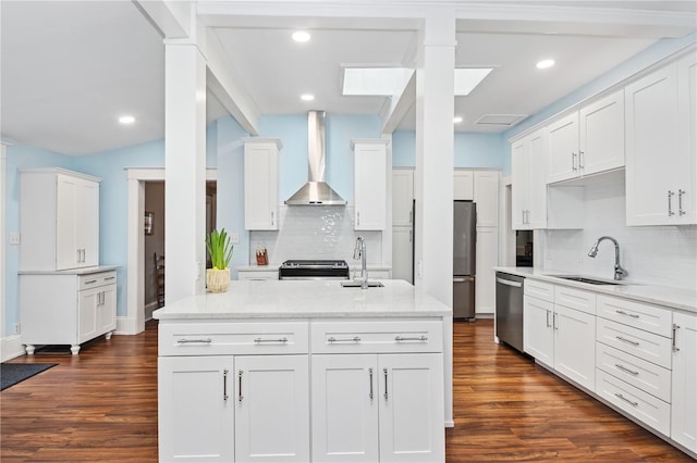 404 N Clara Ave, Deland, FL 32720 - kitchen with wall chimney exhaust hood, appliances with stainless steel finishes, white cabinetry, decorative backsplash, and recessed lighting
