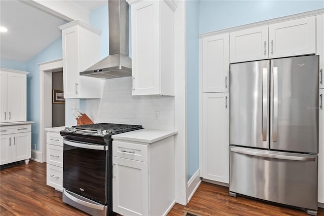 404 N Clara Ave, Deland, FL 32720 - kitchen featuring appliances with stainless steel finishes, wall chimney range hood, backsplash, light countertops, and dark wood-style flooring