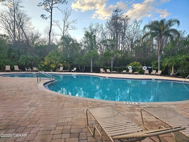 141 Campanello Ct, Daytona Beach, FL 32117 - community pool featuring a patio area and view of wooded area