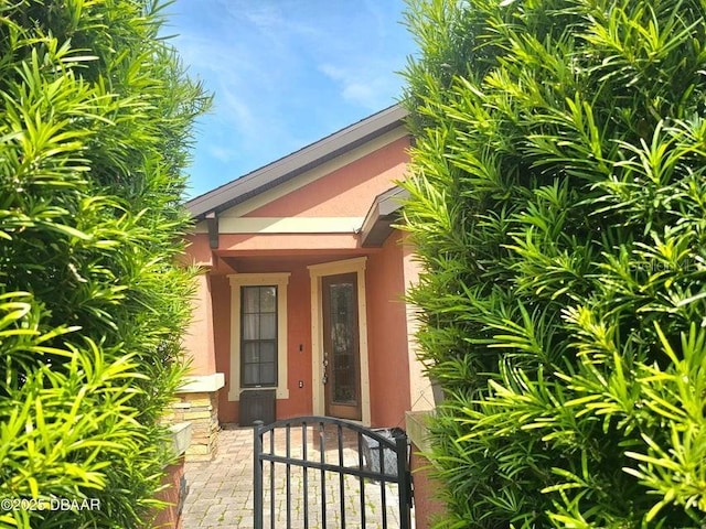 141 Campanello Ct, Daytona Beach, FL 32117 - doorway to property featuring stucco siding