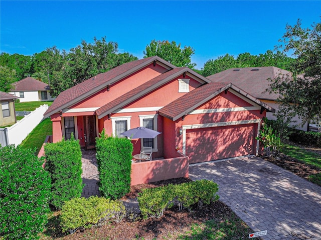 141 Campanello Ct, Daytona Beach, FL 32117 - view of front of home with an attached garage, stucco siding, and decorative driveway