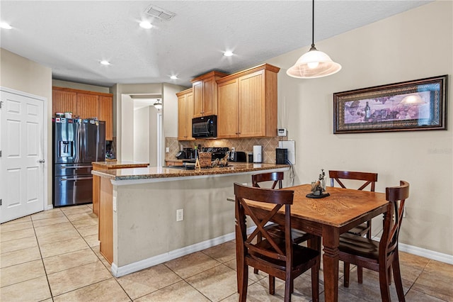141 Campanello Ct, Daytona Beach, FL 32117 - kitchen with black appliances, tasteful backsplash, a peninsula, light tile patterned floors, and recessed lighting
