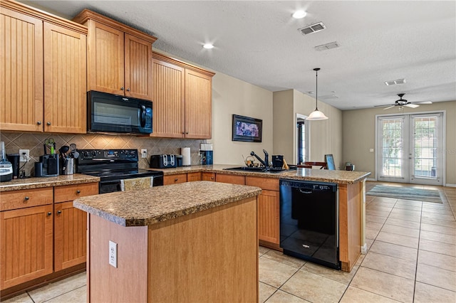 141 Campanello Ct, Daytona Beach, FL 32117 - kitchen featuring black appliances, a sink, a peninsula, tasteful backsplash, and a center island