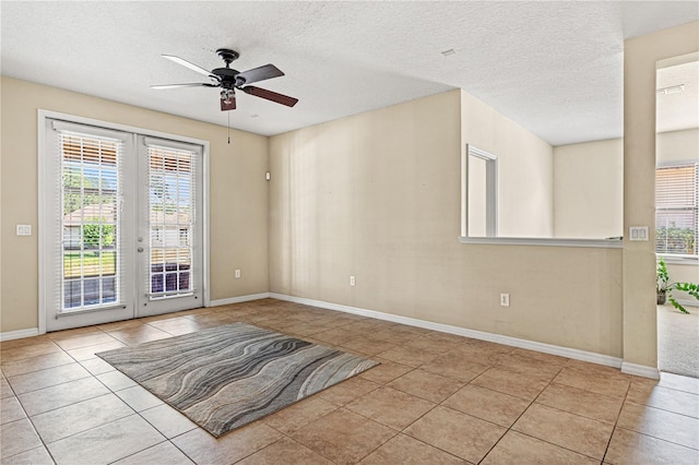 141 Campanello Ct, Daytona Beach, FL 32117 - tiled empty room with french doors, a ceiling fan, a textured ceiling, and baseboards