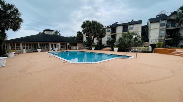 pool with fence and a patio area