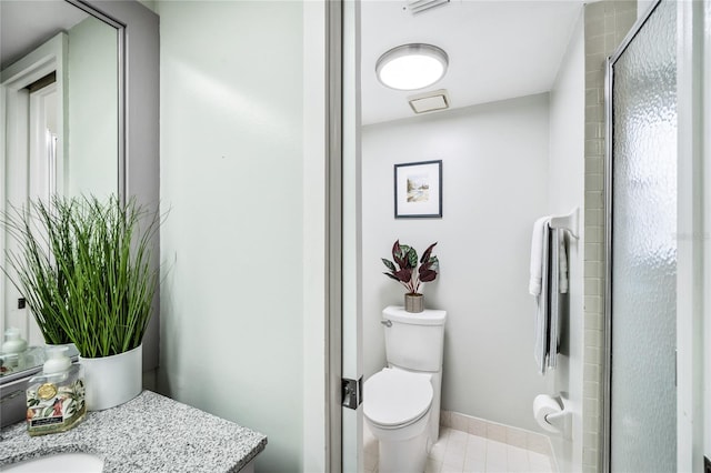 full bath featuring toilet, vanity, an enclosed shower, baseboards, and tile patterned flooring