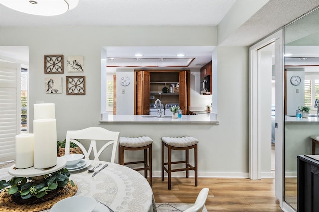 dining area featuring wood finished floors, baseboards, and recessed lighting