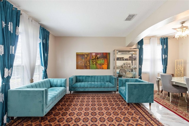 living room with arched walkways and visible vents
