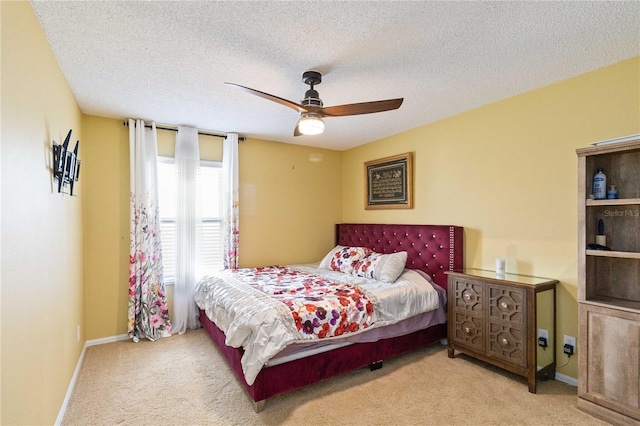 bedroom with a textured ceiling, baseboards, and carpet floors
