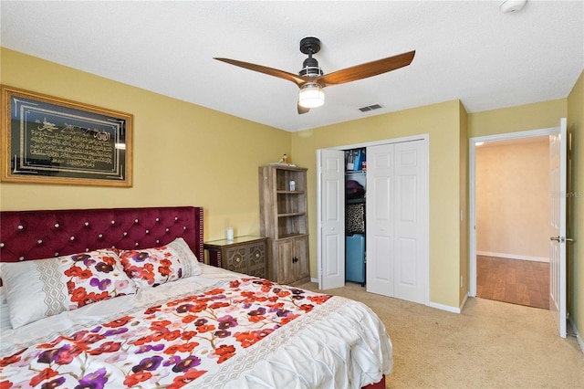 carpeted bedroom with baseboards, visible vents, ceiling fan, and a closet