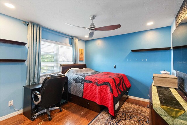 bedroom featuring baseboards, recessed lighting, wood finished floors, and ceiling fan