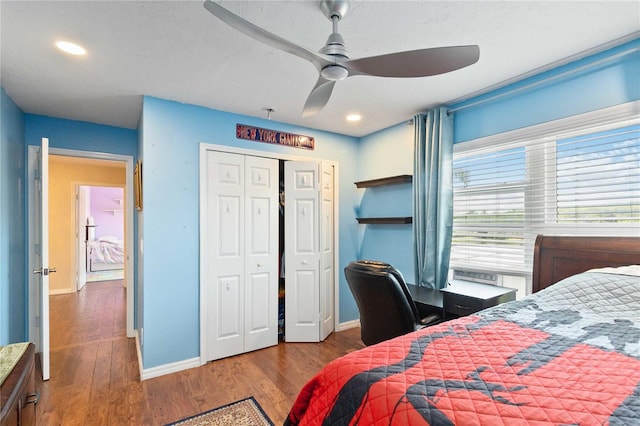 bedroom featuring wood finished floors, a closet, recessed lighting, and baseboards