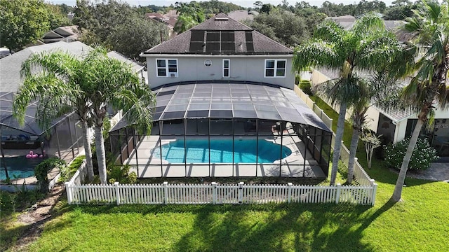 back of property featuring a patio, glass enclosure, a fenced in pool, and a fenced backyard