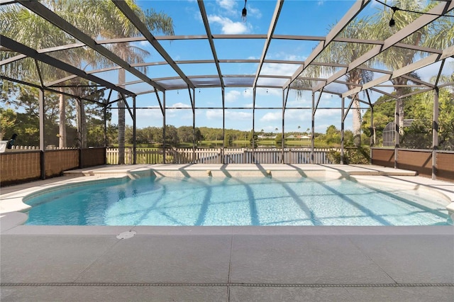 outdoor pool with a patio and glass enclosure