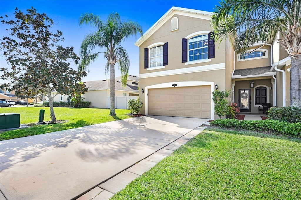 3139 Arden Cir, Melbourne, FL 32934 - view of front of home featuring concrete driveway, fence, an attached garage, a front yard, and stucco siding