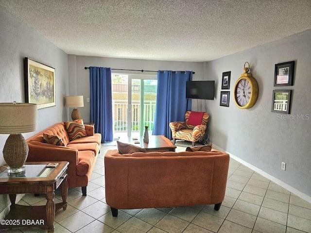 145 N Halifax Ave Unit 205, Daytona Beach, FL 32118 - living room with a textured wall, a textured ceiling, and light tile patterned floors