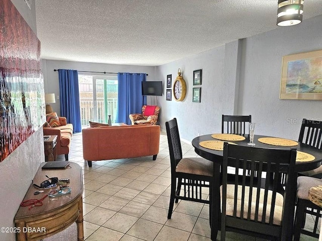 145 N Halifax Ave Unit 205, Daytona Beach, FL 32118 - dining space featuring a textured wall, a textured ceiling, and light tile patterned floors