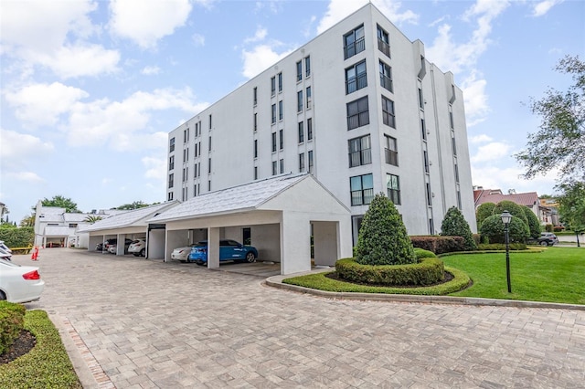 view of building exterior with covered parking