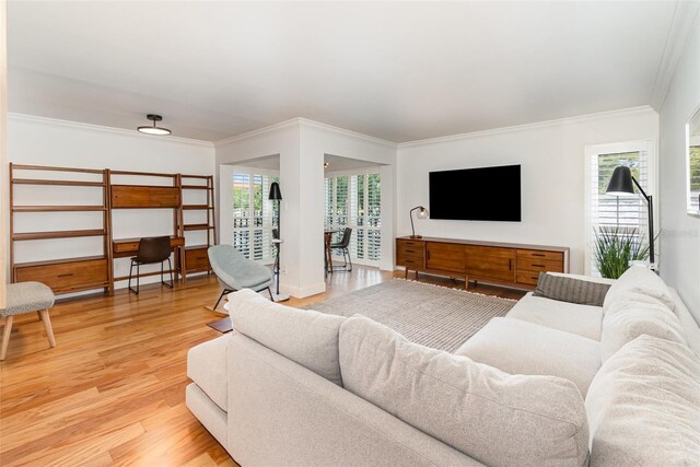 living area with wood finished floors and ornamental molding