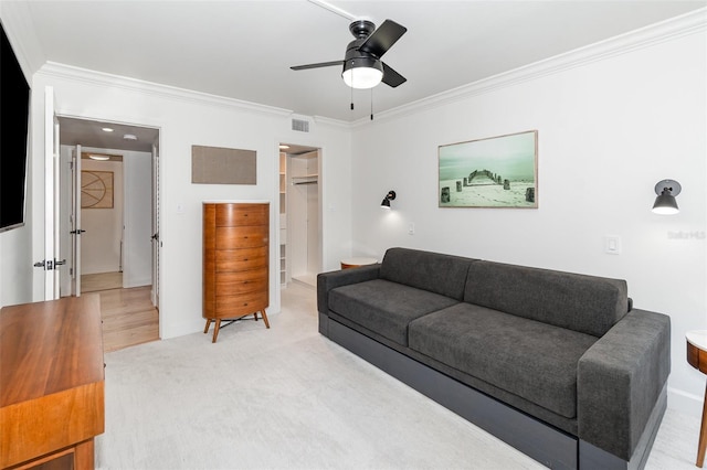 living room featuring visible vents, a ceiling fan, light colored carpet, and ornamental molding