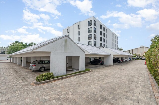 view of building exterior with covered parking