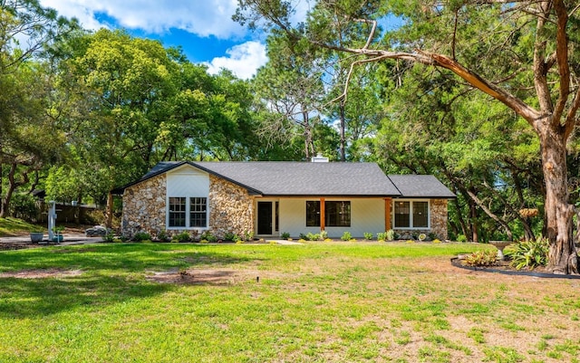 ranch-style home with stone siding and a front yard