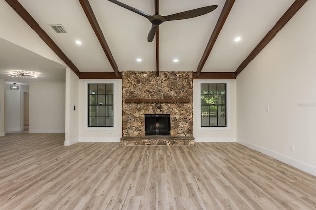 unfurnished living room featuring lofted ceiling with beams, baseboards, wood finished floors, ceiling fan, and a fireplace