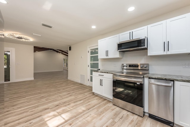 kitchen with white cabinets, stainless steel appliances, and visible vents