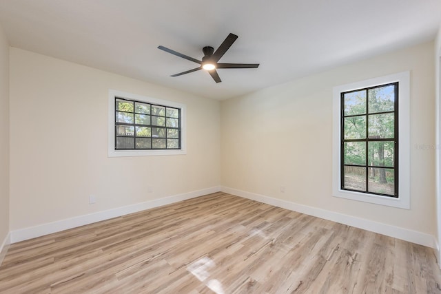 empty room featuring ceiling fan, baseboards, and light wood-style floors