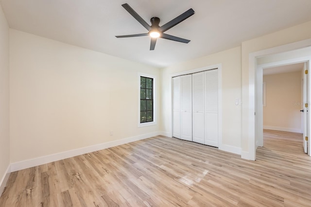 unfurnished bedroom with a ceiling fan, baseboards, a closet, and light wood-type flooring